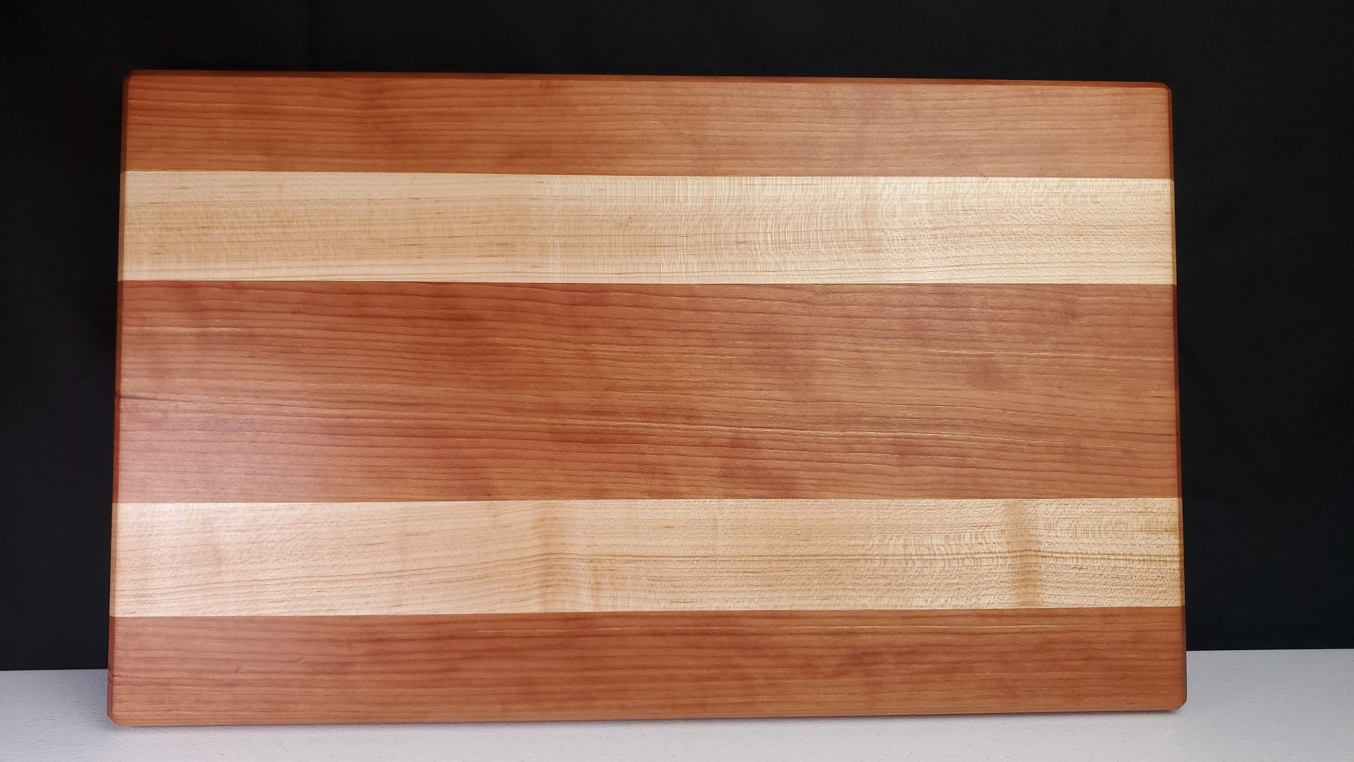 https://nathanswoodcrafts.com/cdn/shop/products/cherry-and-maple-cutting-board-948301.jpg?v=1688555555&width=1946